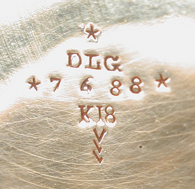 Stamped characters inside the gold watch case.